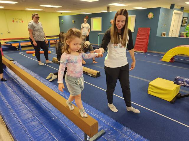 131661510_web1_scarlett.walks.the.beam
Scarlett Scheich, 3, of Clarks Summit, walks along the balance beam at USA Tiny Tumblers in South Abington Township, holding the hand of Emiia McCormich, who owns and teaches at the preschool gymnastics center.
Mary Therese Biebel | Abington Journal