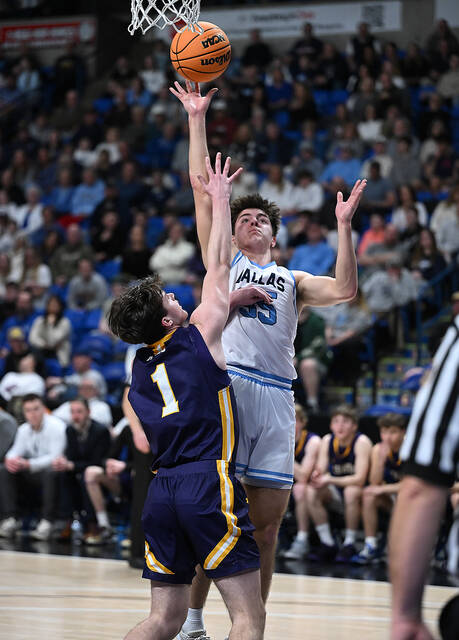 <p>Dallas Mountaineer Talan Geskey (35) hits a lay-up with Scranton Prep’s Max McGrath (1) defending.</p>
<p>Tony Callaio | For Abington Journal</p>