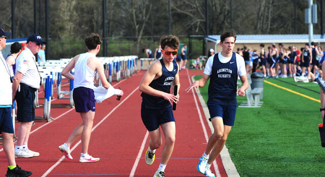 <p>Boys varsity 4 X 800-meter relay, Joe Grad hands the baton to Paul Rollins, left.</p>
<p>Mark Moran | For Abington Journal</p>