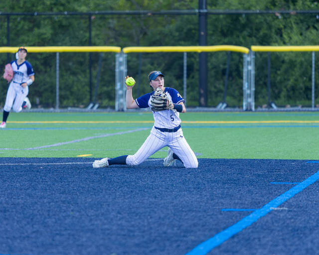 <p>Eva Kane, of Abington Heights tosses to first following a diving stop at second base.</p>